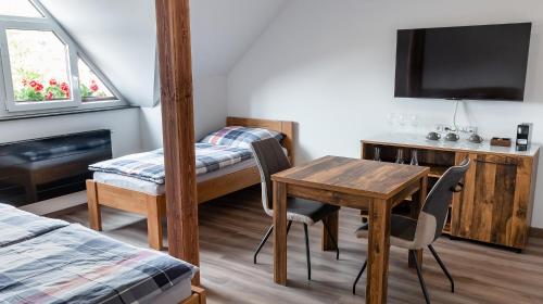 a room with a desk and a table with chairs at Penzion U Kapličky in Malá Hraštice