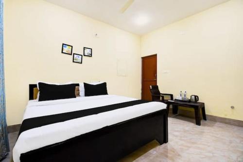 a bedroom with a large bed and a desk at Highway stay in in Bandha Chhada