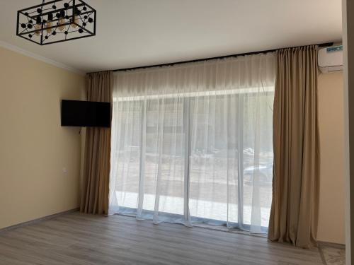 a room with a large window with curtains at Areni Vista Guesthouse in Areni