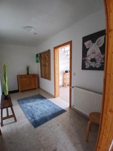 a room with a hallway with a door and a rug at Ferien- und Pferdehof Egelkraut "Feriendomizil am Meer" in Wangerland