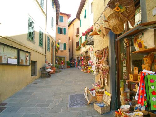 an alley in an old town with a store at Alpine Getaway in Tuscany in Cutigliano