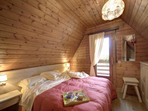 a bedroom with a bed with a tray of food on it at Alpine Getaway in Tuscany in Cutigliano