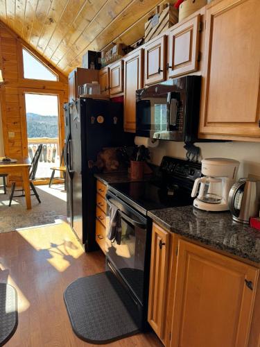 a kitchen with a stove and a refrigerator at Lake Christopher Cabin in Bryant Pond