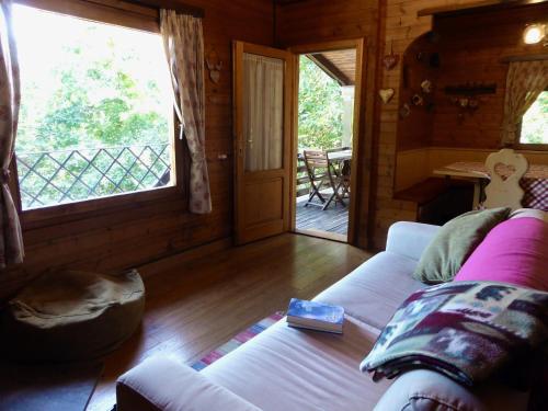 a living room with a couch and a large window at Alpine Getaway in Tuscany in Cutigliano