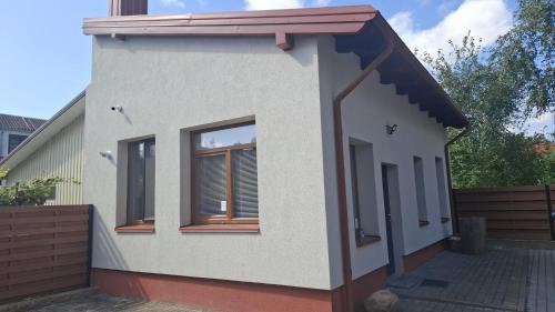 a rendering of a small house at S Neries 19 apartamentai su parkingu in Šiauliai