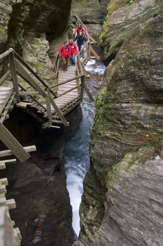 a group of people on a bridge over a river at Appartementhaus Sporthotel Mölltal in Flattach