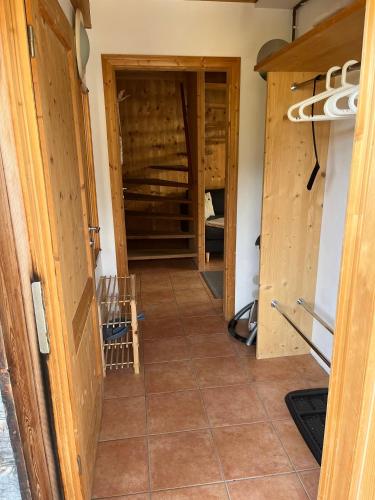 a hallway in a house with wooden walls and tile floors at Feriendorf Tauerngast in Hohentauern