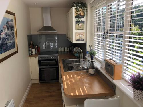 a kitchen with a counter and a sink and a window at The Nest Danehill in Haywards Heath