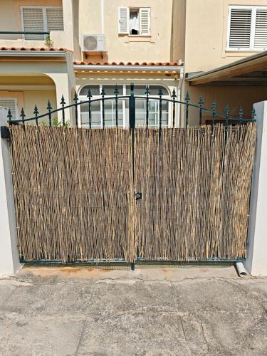 a wooden fence in front of a house at Santos Studio in FAO