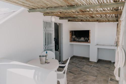 a room with a table and chairs and a fireplace at Paters Nessie in Paternoster
