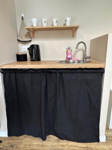 a kitchen island with a black table cloth on it at Le petit Arrigade in Mimbaste