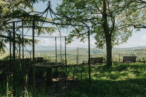 a gazebo with a table and benches in a field at Laura in Rapale
