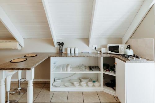 a kitchen with a table and a counter top at Paters Nessie in Paternoster