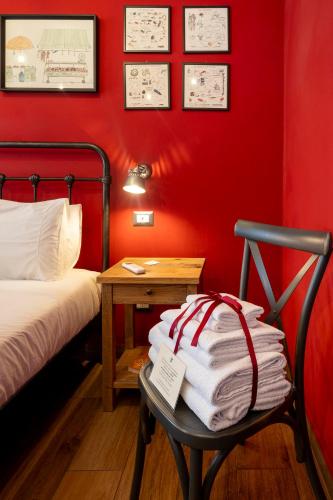 a room with a bed and a chair with a table at il Palchetto B&B di Charme e Design in Palermo