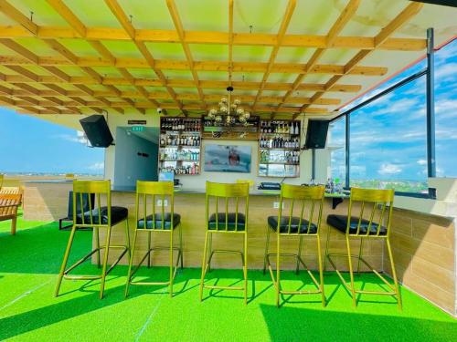 a room with chairs and a table with a bar at KIjichi gateway Hotel in Dar es Salaam