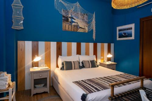 a bedroom with a bed with blue walls at il Palchetto B&B di Charme e Design in Palermo