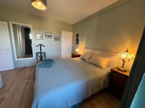 Кровать или кровати в номере Le Lodge de Serenite