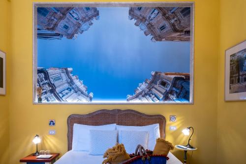 a bedroom with a large mirror above a bed at il Palchetto B&B di Charme e Design in Palermo