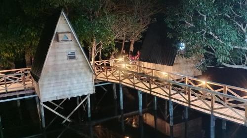 a wooden bridge over the water at night at Amazon Private Tours Jungle Lodge in Manacapuru