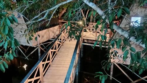 a wooden bridge over a river at night at Amazon Private Tours Jungle Lodge in Manacapuru