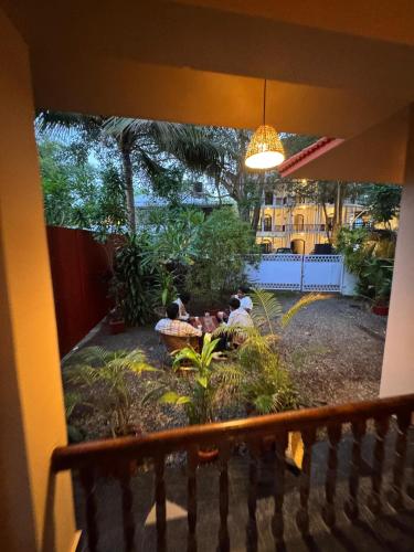 a group of people sitting in a garden at BEACHO 2 bhk private entire villa southcliff varkala in Varkala