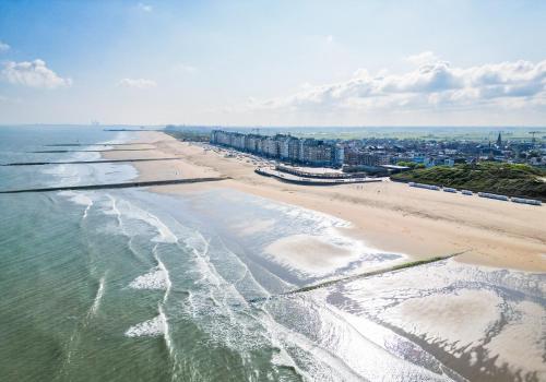 an aerial view of a beach with buildings and the ocean at Hoeve Langhof in Wenduine