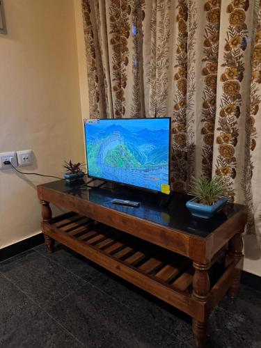 a flat screen tv sitting on top of a table at BEACHO 2 bhk private entire villa southcliff varkala in Varkala