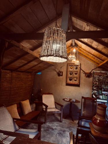 a large room with chairs and a chandelier at Villa Bird Gate in Galle