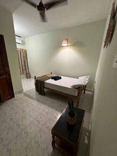 a room with a bed and a table in it at BEACHO 2 bhk private entire villa southcliff varkala in Varkala