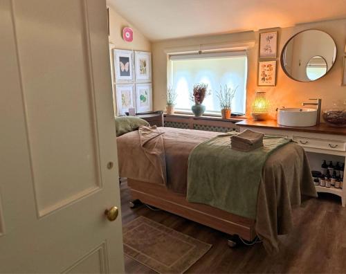 a bedroom with a bed with a sink and a window at Holdsworth House Hotel in Halifax