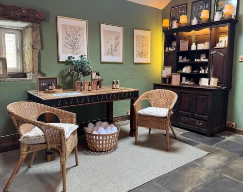 a room with a table and two chairs and a counter at Holdsworth House Hotel in Halifax