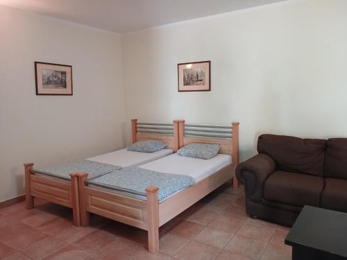 a small bedroom with a bed and a couch at Studio apartman Monte 2 in Tivat