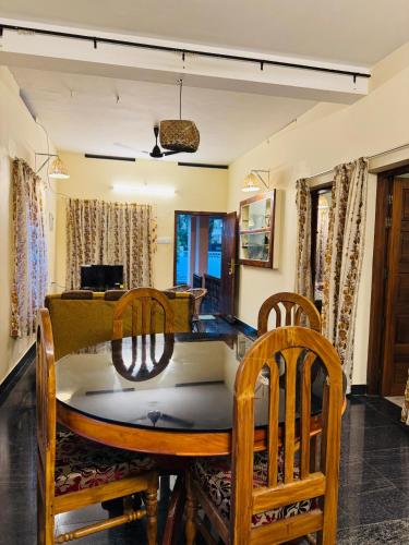 a dining room with a table and chairs at BEACHO 2 bhk private entire villa southcliff varkala in Varkala