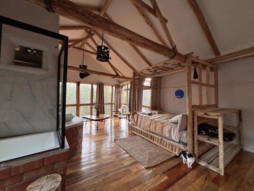 a bedroom with a bed and a tv in a room at Casa de campo Yoga Retreat in Urubamba