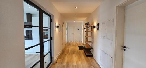 a hallway with a staircase and a room with a window at Lace Apartments Stilvoll in der Spitzenstadt Plauen in Plauen