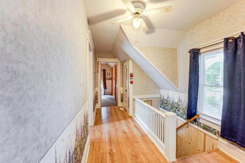 a hallway of a home with a ceiling fan at Cozy Hart Getaway with Fire Pit Less Than 1 Mi to Lake! in Hart
