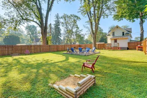 a yard with a chair and a bench and a fence at Cozy Hart Getaway with Fire Pit Less Than 1 Mi to Lake! in Hart