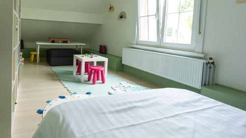 a bedroom with a bed and a table and a table at Nethehuis in Kasterlee