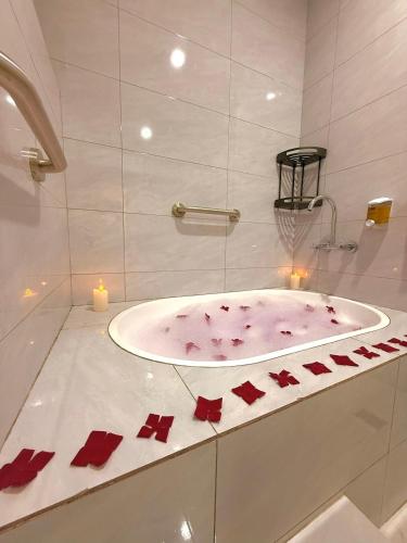 a bathroom with a bath tub with red crystals at KIjichi gateway Hotel in Dar es Salaam