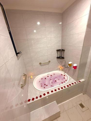 a bathroom with a pink bath tub in a shower at KIjichi gateway Hotel in Dar es Salaam