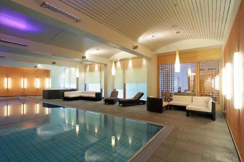 a lobby with a swimming pool in a building at Grand Hotel Zermatterhof in Zermatt