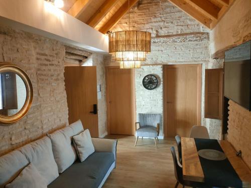 a living room with a couch and a table at Arena Centro Rooms&Suites in Seville