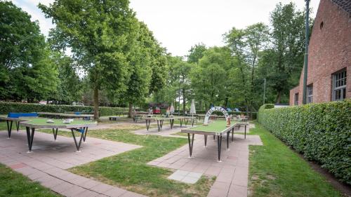 a group of picnic tables in a park at Nethehuis in Kasterlee