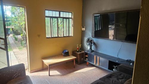 a living room with a large flat screen tv at Sítio do Marcelo in Santa Bárbara