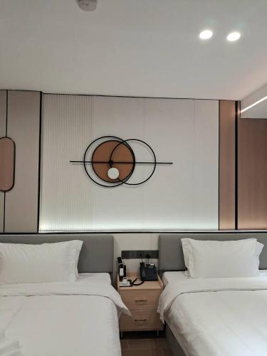 two beds in a room with a basketball on the wall at man tony hotel in Ban Nong Chaeng