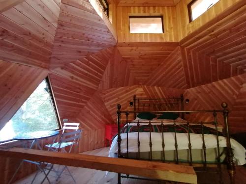 a bedroom in a tree house with a bed in it at Domo Conguillío in Melipeuco