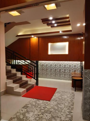 a staircase in a house with a red carpet at Hotel Golden Inn in Sylhet