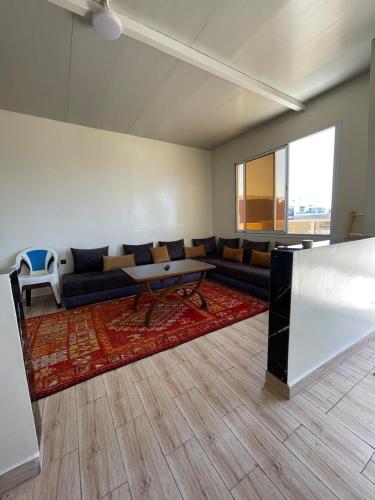 a living room with a couch and a table at Imsouane Vibe Surf house in Imsouane