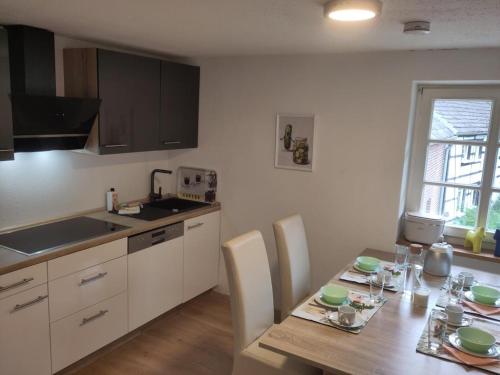 a kitchen with a wooden table and a dining room at NEU! Moderne FeWo in Bönen in Bönen