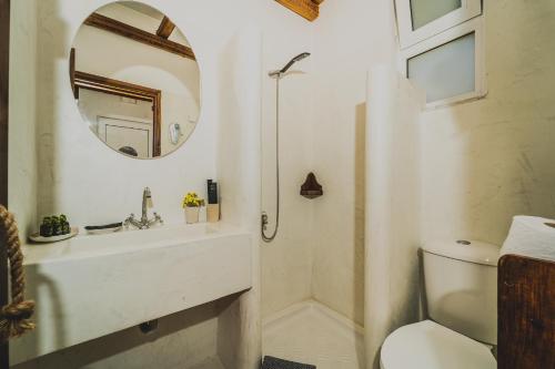 a bathroom with a sink and a mirror at Limeri Traditional Guest House in Monólithos